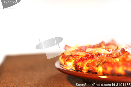 Image of pizza on the brown plate, isolated