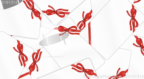 Image of mess of white gift cards with red ribbon and bow
