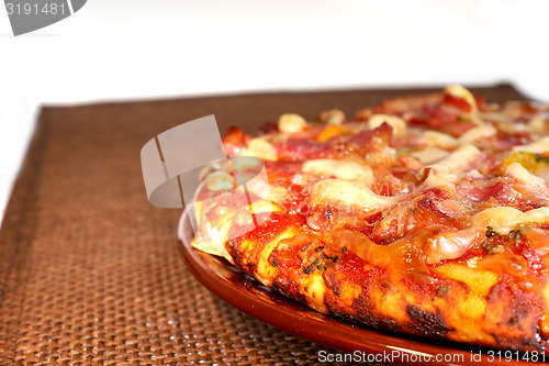 Image of pizza on the brown plate, isolated