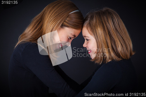 Image of Portrait of friends touching face to face