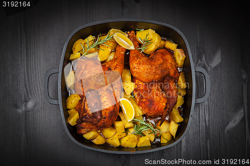 Image of Baked chicken on potatoes
