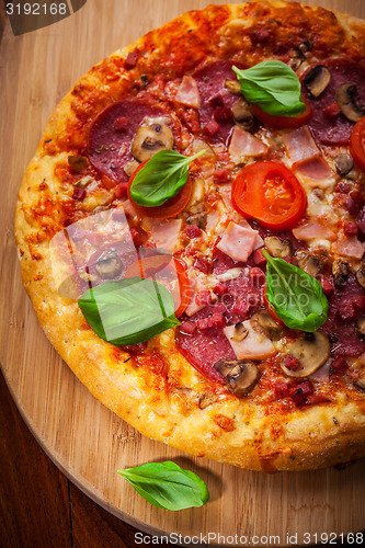 Image of Traditional pizza with salami and mushrooms