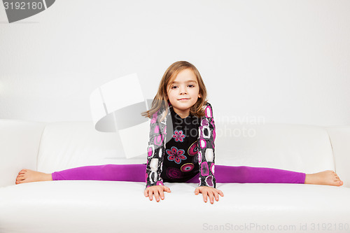 Image of Cute little girl making splits