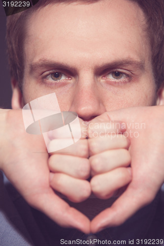 Image of Speak no evil concept - Face of men covering his mouth. 