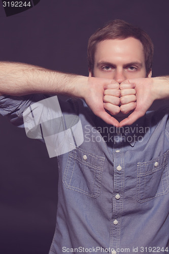 Image of Speak no evil concept - Face of men covering his mouth. 