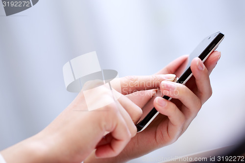 Image of Close up of a woman using smartphone