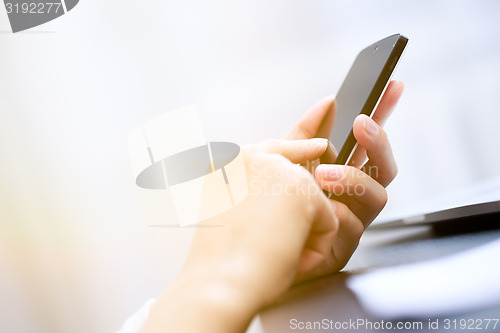 Image of Close up of a woman using smartphone