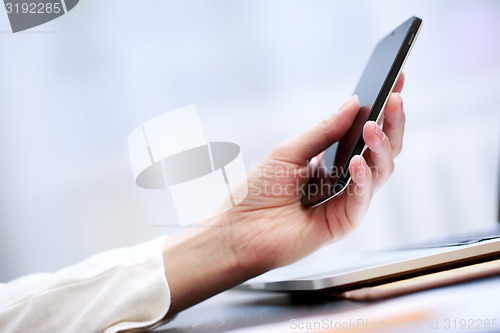 Image of Close up of a woman using smartphone