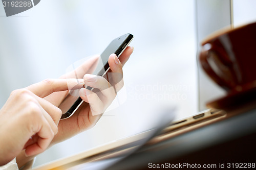 Image of Close up of a woman using smartphone