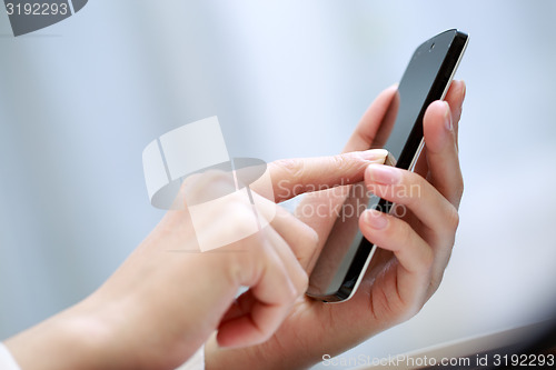 Image of Close up of a woman using smartphone