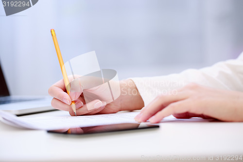 Image of Female hand writing, close up