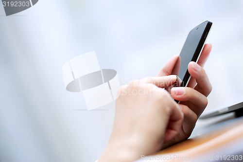 Image of Close up of a woman using smartphone