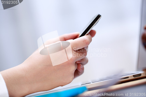 Image of Close up of a woman using smartphone