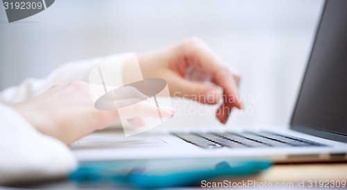 Image of Close-up shot typing on the laptop keyboard