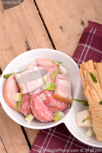 Image of salami and cheese on white plate