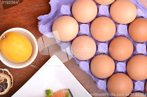 Image of egg, lemon and red fish