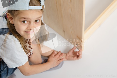 Image of Girl in overalls collector furniture screw spins