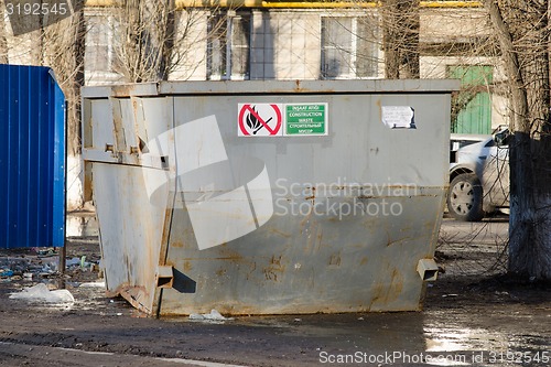 Image of Large garbage container on the background of dirty streets