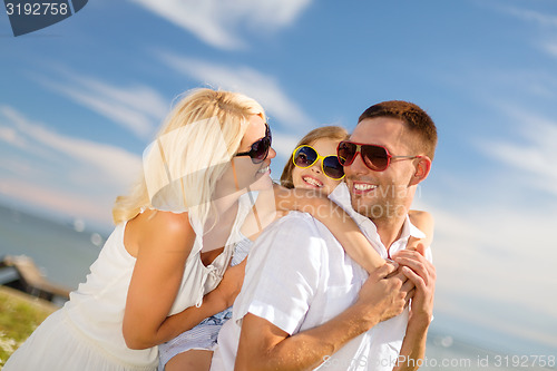 Image of happy family in sunglasses having fun outdoors