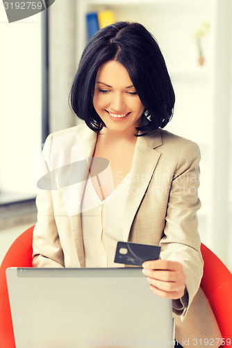 Image of happy woman with laptop computer and credit card