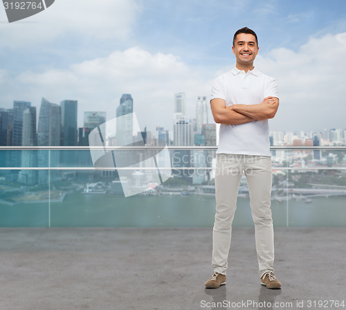 Image of smiling man with crossed arms