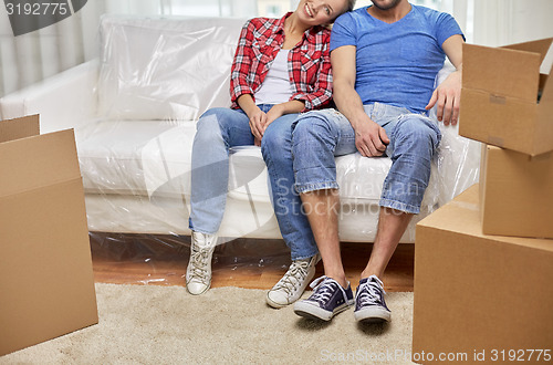 Image of close up of couple relaxing on sofa in new home