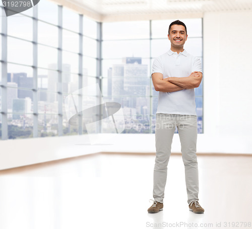 Image of smiling man with crossed arms