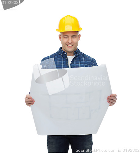 Image of smiling male builder in helmet with blueprint