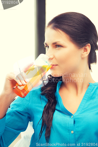 Image of beautiful woman with glass of juice