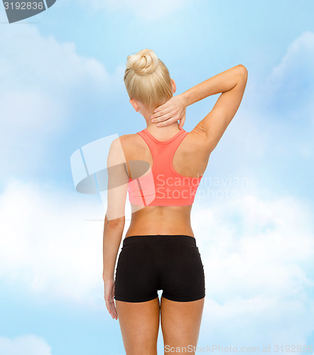 Image of sporty woman touching her neck