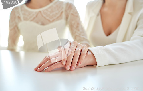 Image of close up of happy married lesbian couple hugging