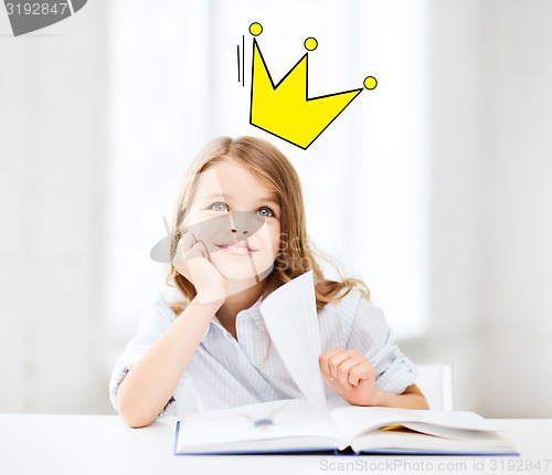 Image of smiling girl reading fairytales at home