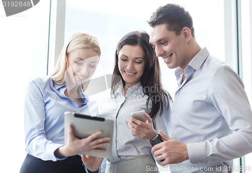 Image of business team working with tablet pcs in office