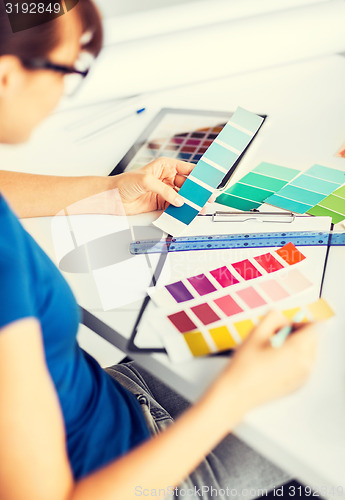 Image of woman working with color samples for selection