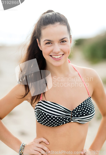 Image of happy young woman on beach