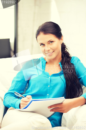 Image of happy woman with big notepad