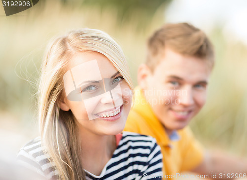 Image of group of happy couple on beach
