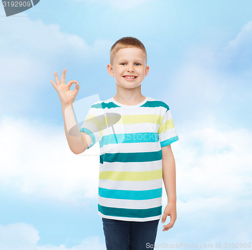 Image of little boy in casual clothes making ok gesture