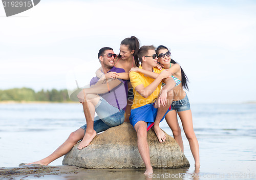 Image of happy friends on summer beach