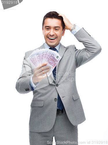 Image of happy laughing businessman with euro money