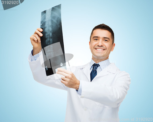 Image of smiling male doctor in white coat holding x-ray