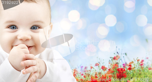 Image of beautiful happy baby over poppy field background