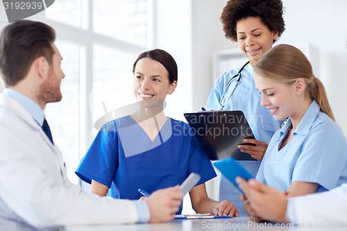 Image of group of happy doctors meeting at hospital office