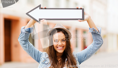 Image of girl showing direction with arrow in the city