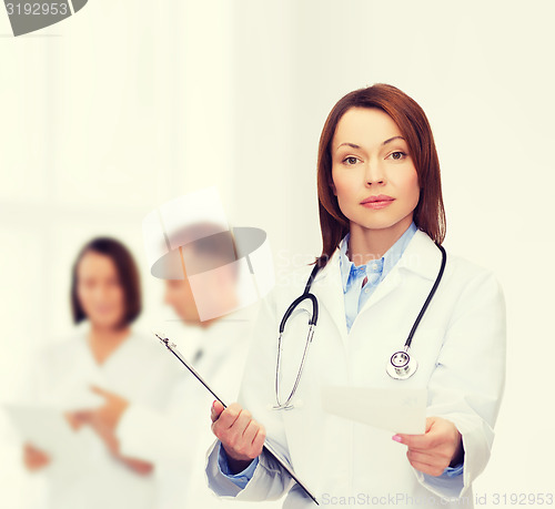 Image of calm female doctor with clipboard