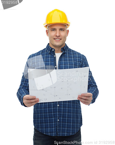 Image of smiling male builder in helmet with blueprint