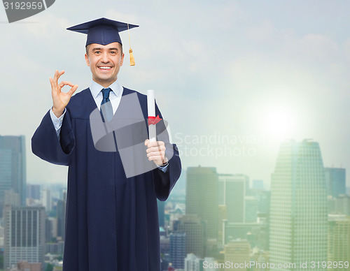 Image of smiling adult student in mortarboard with diploma