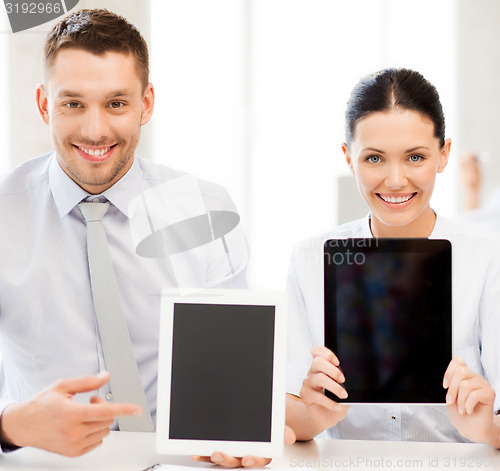 Image of business team showing tablet pcs in office