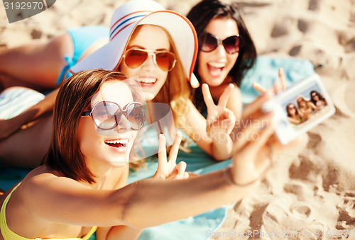 Image of girls taking self photo on the beach