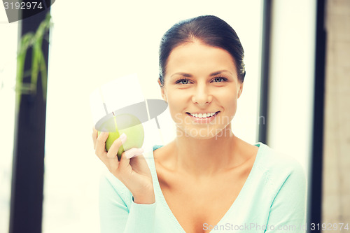 Image of lovely housewife with green apple